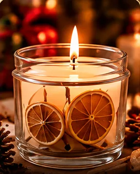 Vela aromática en vaso de vidrio con rodajas de naranja